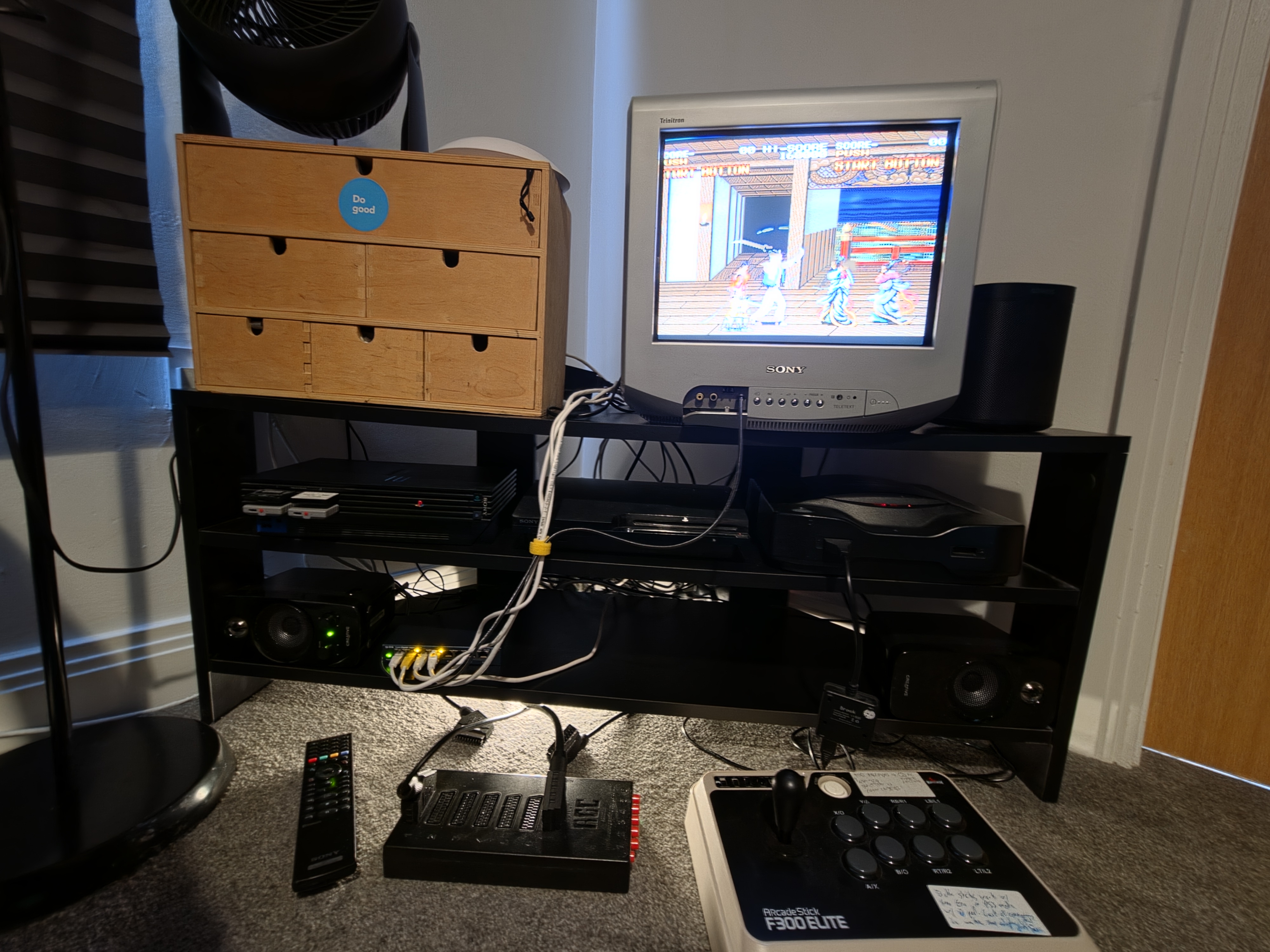 A picture of my cathode ray tube (CRT) TV in my bedroom with PS2, PS3 and Neo Geo CD consoles underneath it in a TV stand.